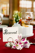 Reserved sign on restaurant table with empty dishes and glasses
