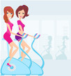 Indoor Cycling - Girls cycling at Gym
