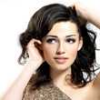 Face of the beautiful woman with curly brown hairs