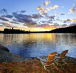 Photo: Wooden chairs at sunset on beach Wooden chairs at sunset on beach