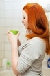  girl gargles her throat in bathroom
