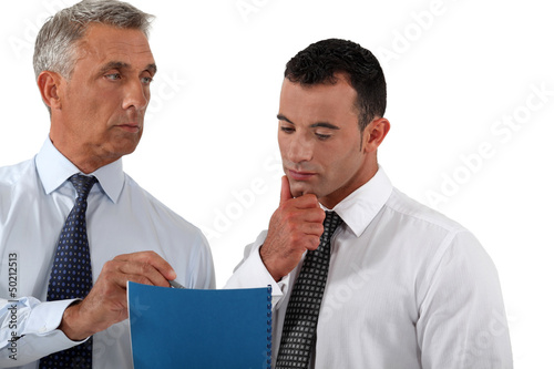 Photo: Businessmen discussing a document Businessmen discussing a document