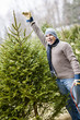 Man with Christmas tree on a farm
