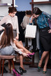 Friends help to choose an appropriate suitable shoes
