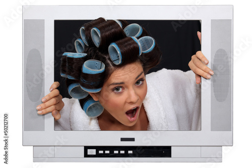 Photo: girl in TV screen with hair curlers girl in TV screen with hair curlers
