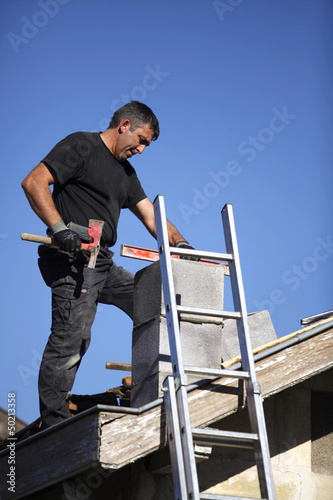 Photo: Man building chimney Man building chimney