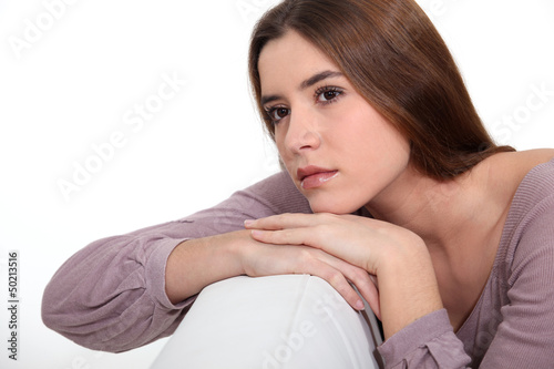 Photo: Brunette daydreaming on sofa Brunette daydreaming on sofa