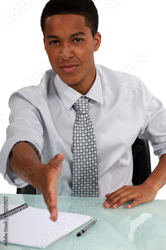 Photo: black executive holding out hand to shake hands black executive holding out hand to shake hands