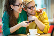 Young couple in cafe, laughing