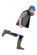 Speedy tradesman holding a blank sign