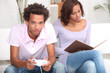 Couple reading and playing computer games