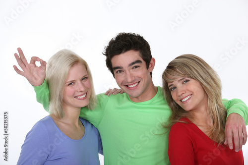 Photo: Man hugging two women Man hugging two women