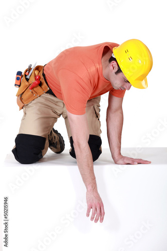 Photo: Construction worker reaching down Construction worker reaching down