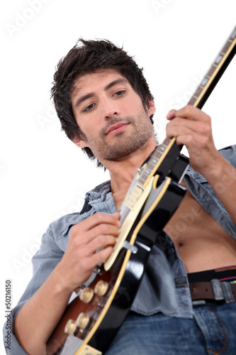Photo: young man playing electrical guitar young man playing electrical guitar