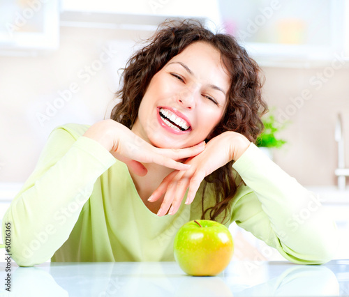 Photo: Dieting concept. Healthy Food. Young Woman Eats Fresh Fruit Dieting concept. Healthy Food. Young Woman Eats Fresh Fruit