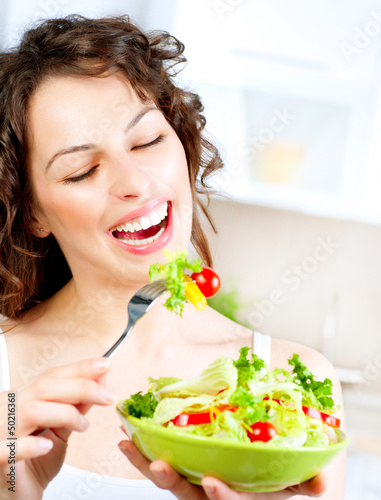 Photo: Diet. Beautiful Young Woman Eating Vegetable Salad Diet. Beautiful Young Woman Eating Vegetable Salad