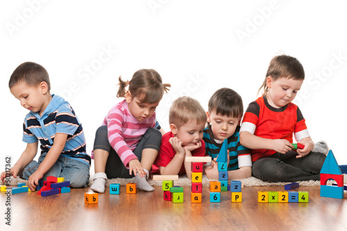 Photo: Five kids playing on the floor Five kids playing on the floor
