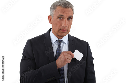Photo: Executive pulling businesscard from pocket Executive pulling businesscard from pocket