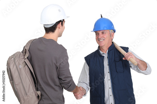 Photo: Builder welcoming teenage helper Builder welcoming teenage helper