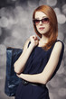 Style redhead girl with shopping bags.