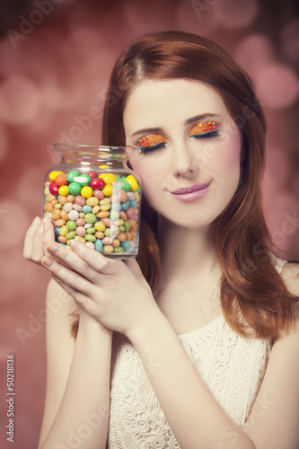 Photo: young woman holding a bowl full of jelly beans young woman holding a bowl full of jelly beans