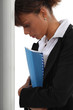 Frustrated woman leaning her head against a wall