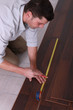 Man measuring flooring