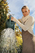 Women in the garden watering her plants