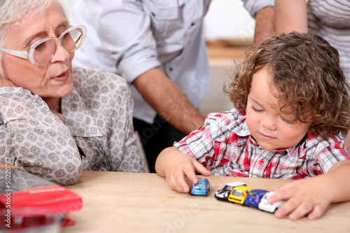 Photo: Grandmother and little boy playing Grandmother and little boy playing