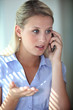 Blond woman having argument over the telephone