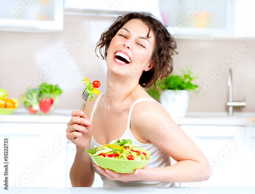 Photo: Diet. Beautiful Young Woman Eating Vegetable Salad Diet. Beautiful Young Woman Eating Vegetable Salad