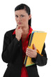 serious businesswoman holding folders