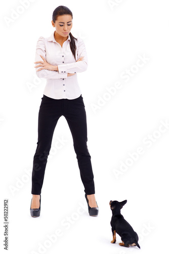 Photo: Sexy brunette model posing against small dog Sexy brunette model posing against small dog