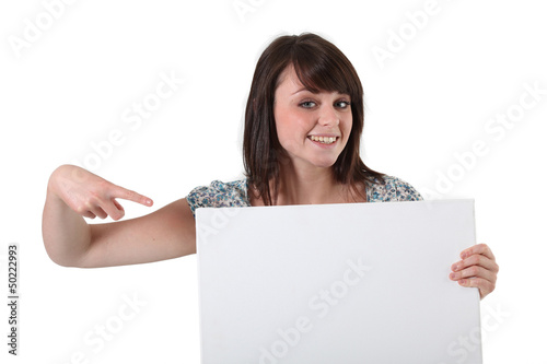 Photo: young woman showing white board young woman showing white board