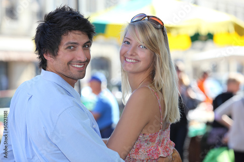 Photo: A couple having a walk in town. A couple having a walk in town.