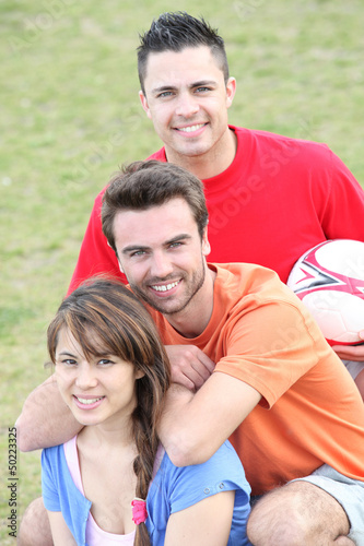 Photo: Young people playing soccer in a park Young people playing soccer in a park
