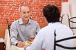 Elderly man out with his grandson for a meal
