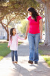 Photo: Mother And Daughter Walking Along Path Mother And Daughter Walking Along Path