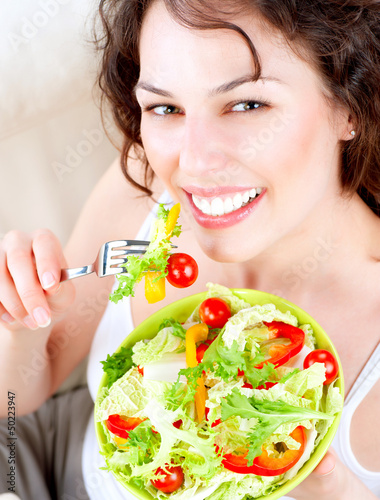 Photo: Diet. Beautiful Young Woman Eating Vegetable Salad Diet. Beautiful Young Woman Eating Vegetable Salad