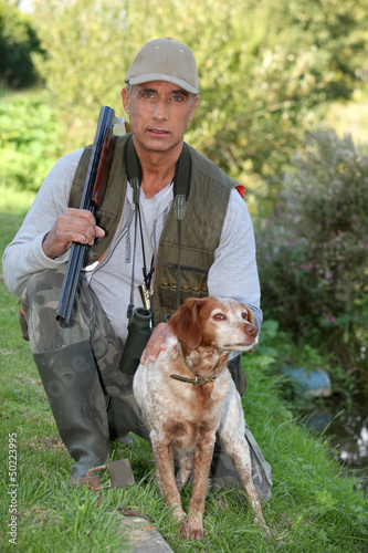 Photo: Hunter kneeling by dog Hunter kneeling by dog