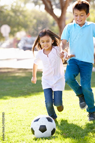 Photo: Two Children Playing Soccer Together Two Children Playing Soccer Together