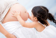 Girl stroking pregnant belly