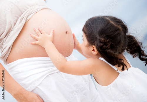 Photo: Girl stroking pregnant belly Girl stroking pregnant belly
