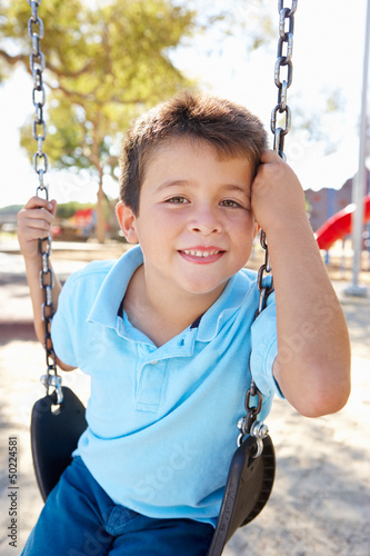 Photo: Boy On Swing In Park Boy On Swing In Park