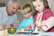 Father and children painting for fun