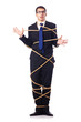 Businessman tied up with rope on white