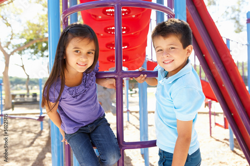 Photo: Boy And Girl On Climbing Frame In Park Boy And Girl On Climbing Frame In Park
