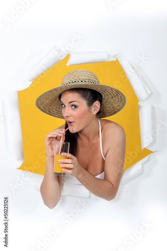 Photo: a woman drinking orange juice a woman drinking orange juice