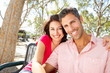 Romantic Couple Sitting On Park Bench Together