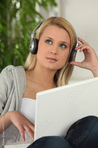 Photo: Young woman listening to music Young woman listening to music